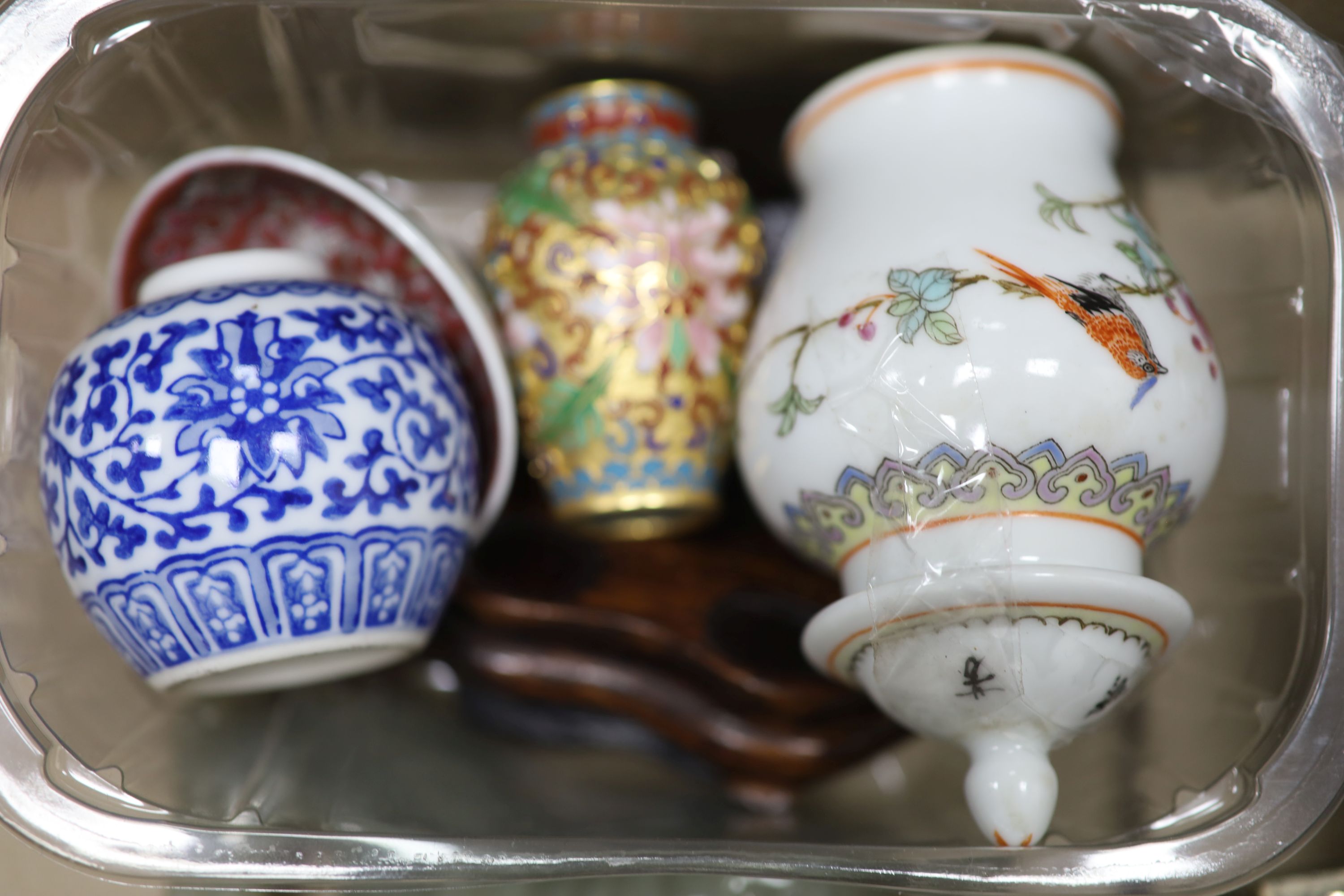 A collection of Chinese hardstone animals, collection of snuff bottles and small ornaments and two stands